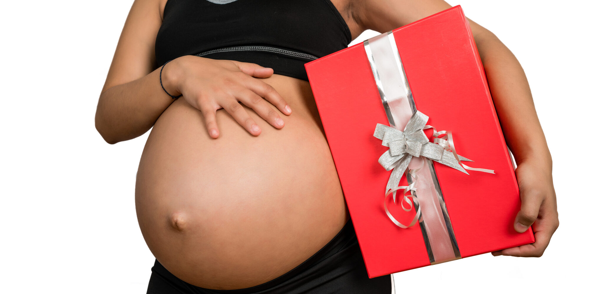 pregnant woman holding a christmas gift box.